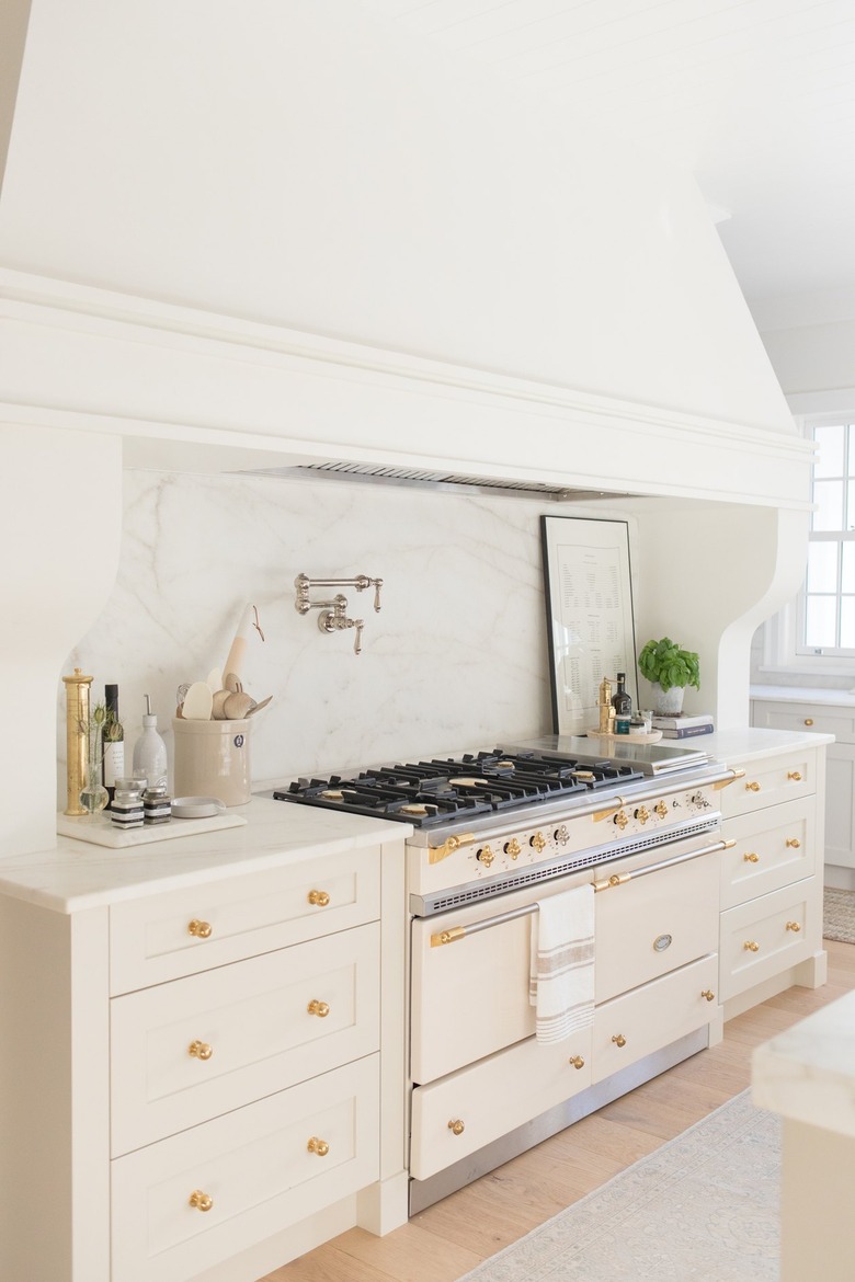 white marble backsplash with cream cabinetry