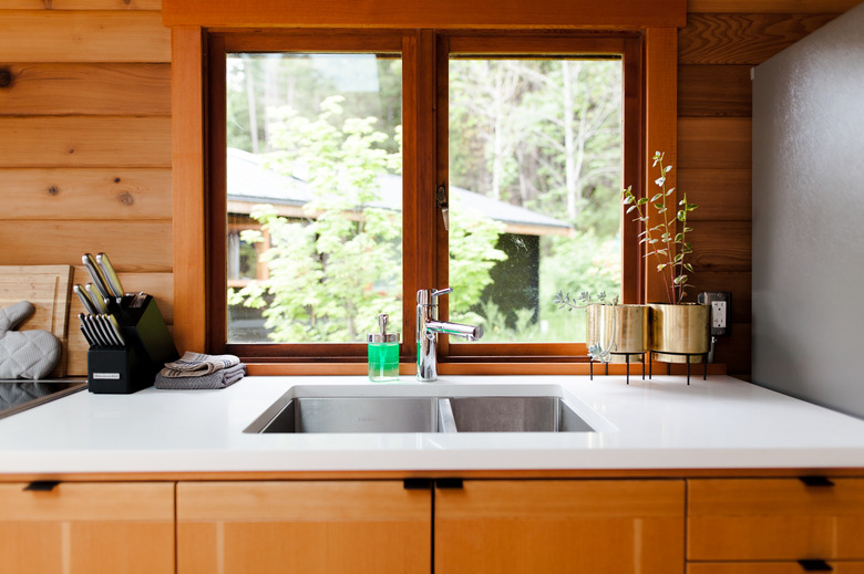 double kitchen sink and kitchen faucet with white countertops