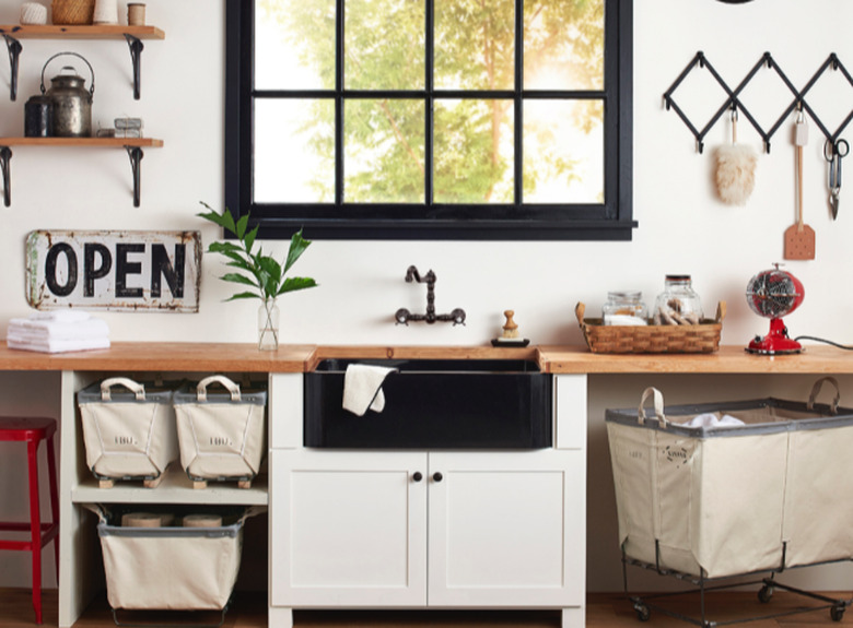 oil-rubbed bronze wall-mounted kitchen faucet and black farmhouse sink with wood countertops