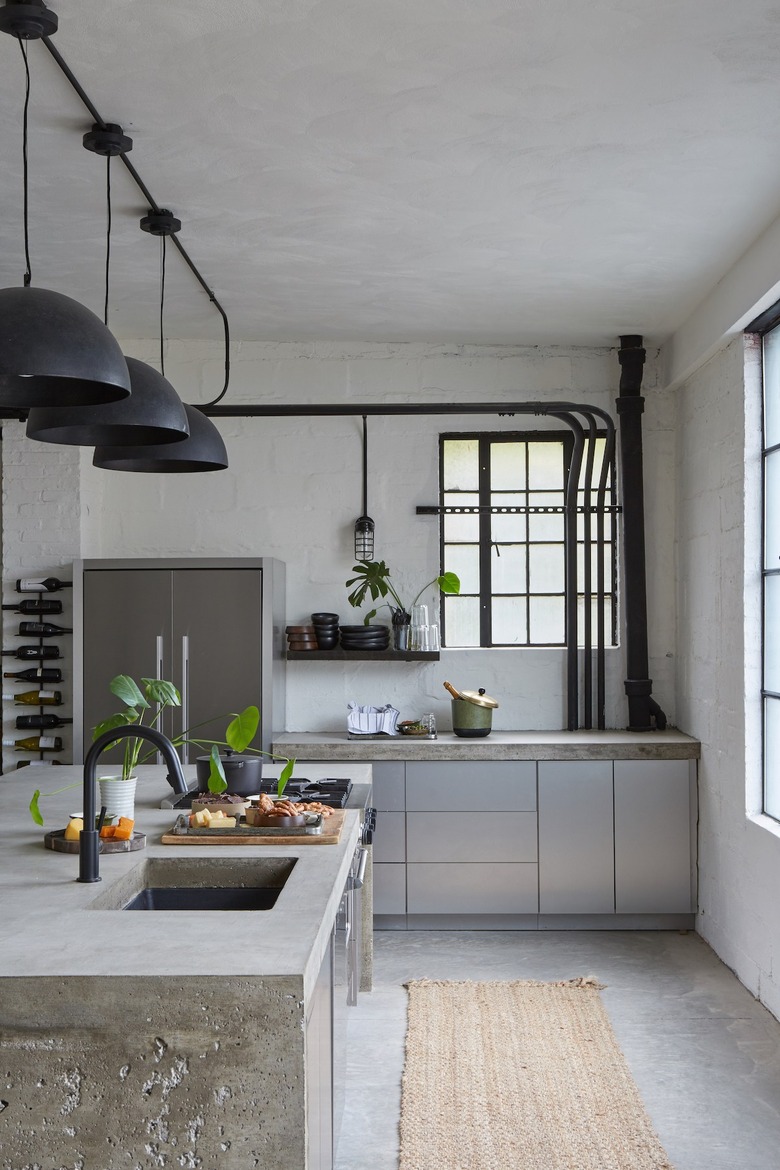 undermount kitchen sink and kitchen faucet with poured concrete countertops