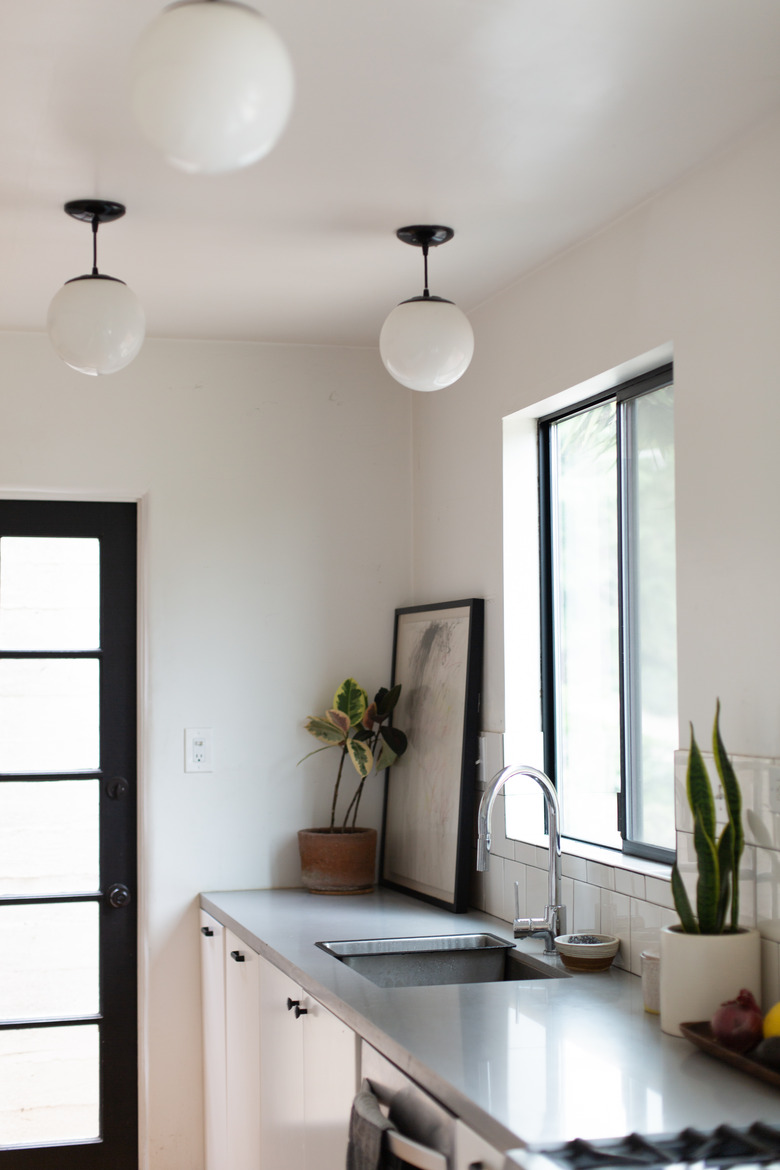 kitchen sink and kitchen faucet in modern space with steel countertops