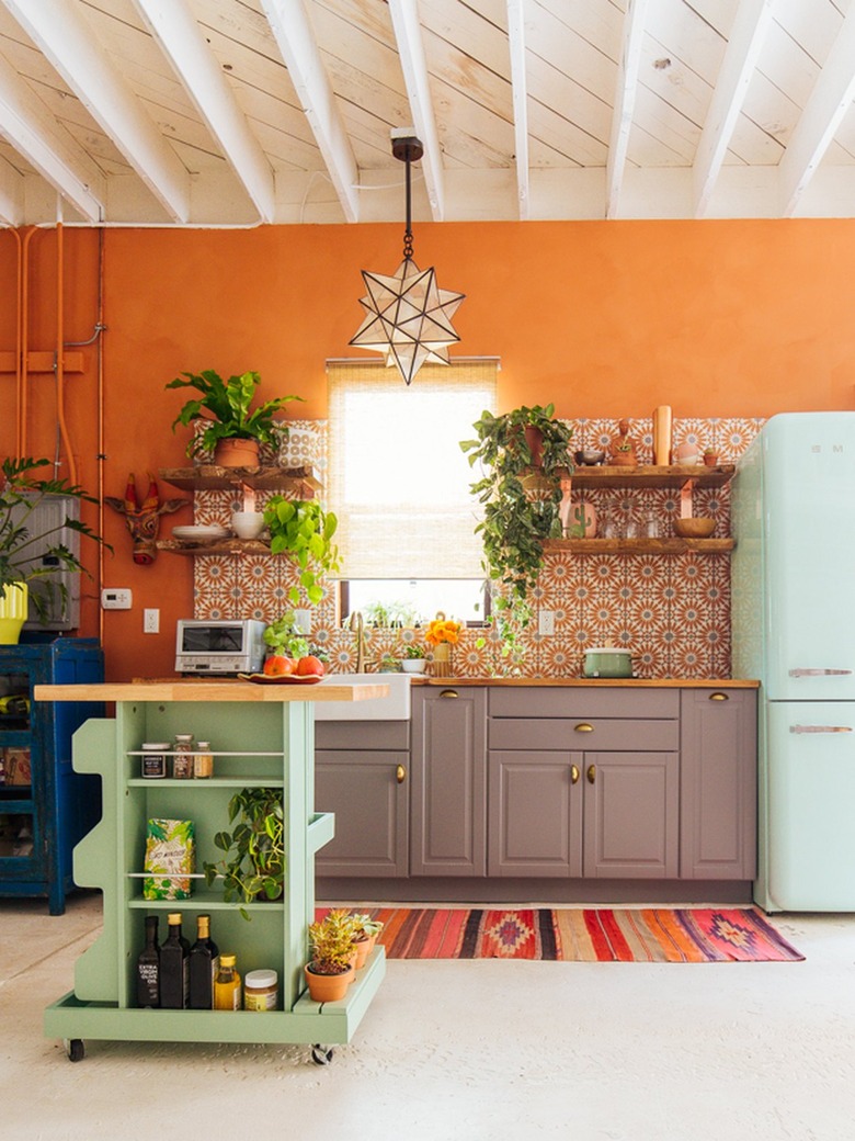 mint green kitchen cart in orange and white bohemian kitchen