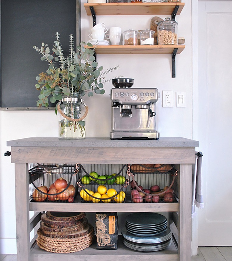 wood farmhouse kitchen cart with wire baskets filled with produce