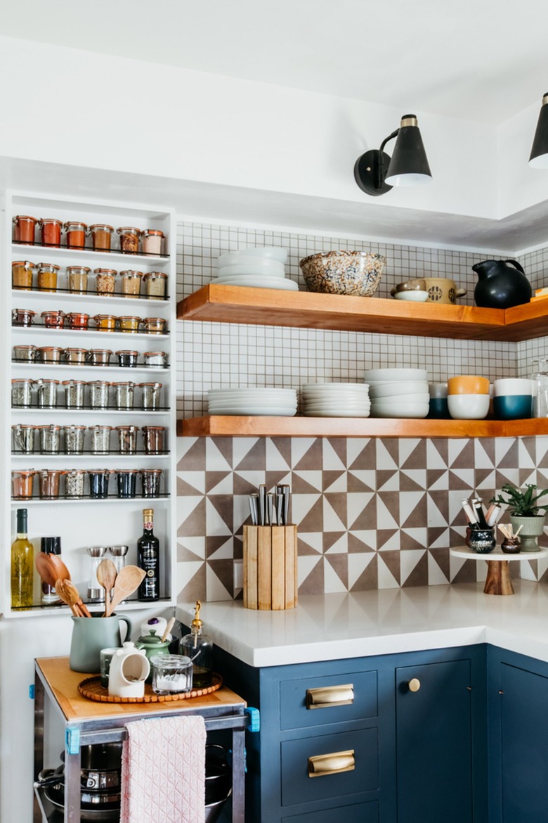 stainless steel kitchen cart next to countertop in blue and white kitchen