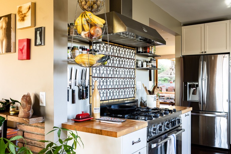 A kitchen with wood countertops and tile backsplash