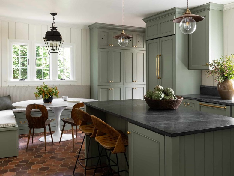 traditional kitchen with green cabinets and soapstone countertops