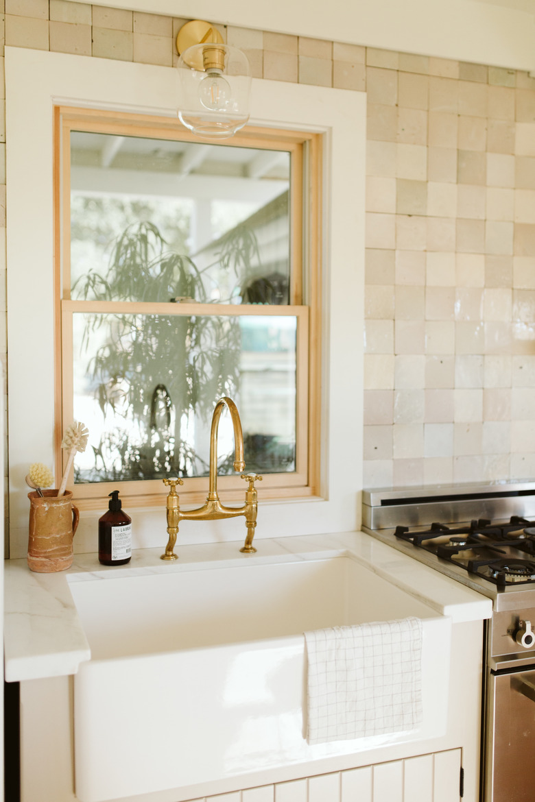 Traditional kitchen window is farmhouse modern kitchen with farmhouse sink and gold faucet