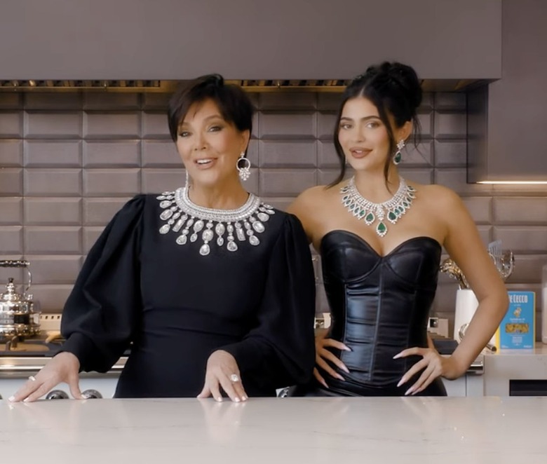 Kris and Kylie Jenner at a kitchen counter dressed in all black