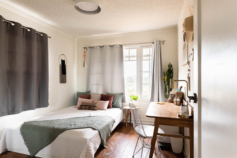 neutral-colored bedroom with hardwood floors