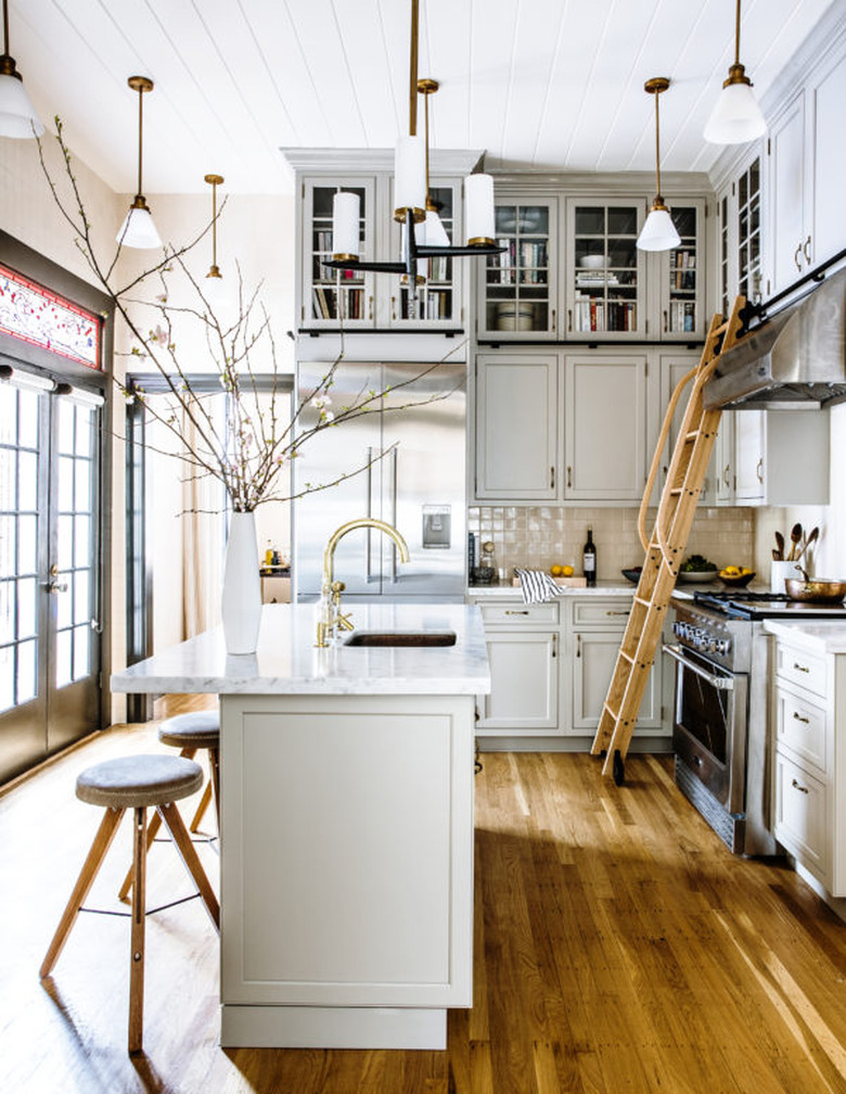 large open kitchen with light blue cabinets and high ceiling