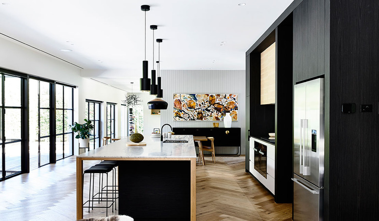 large open kitchen with black cabinets and stainless steel cabinets