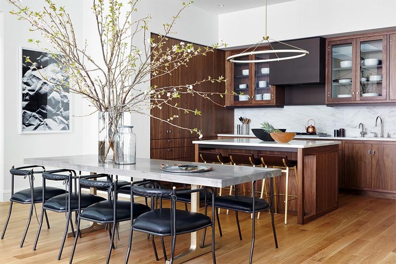 open kitchen with dark wood cabinets and modern chandelier