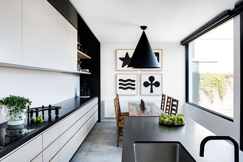 large open kitchen with white cabinets and black accents