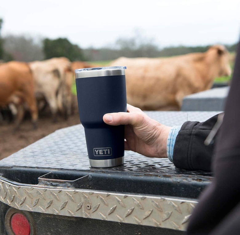 person holding a yeti mug in navy