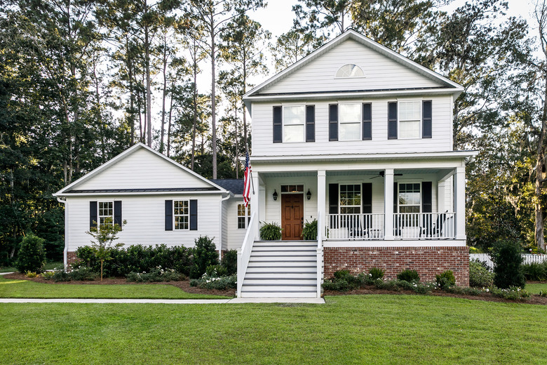 Front of new construction white siding farmhouse in the suburbs