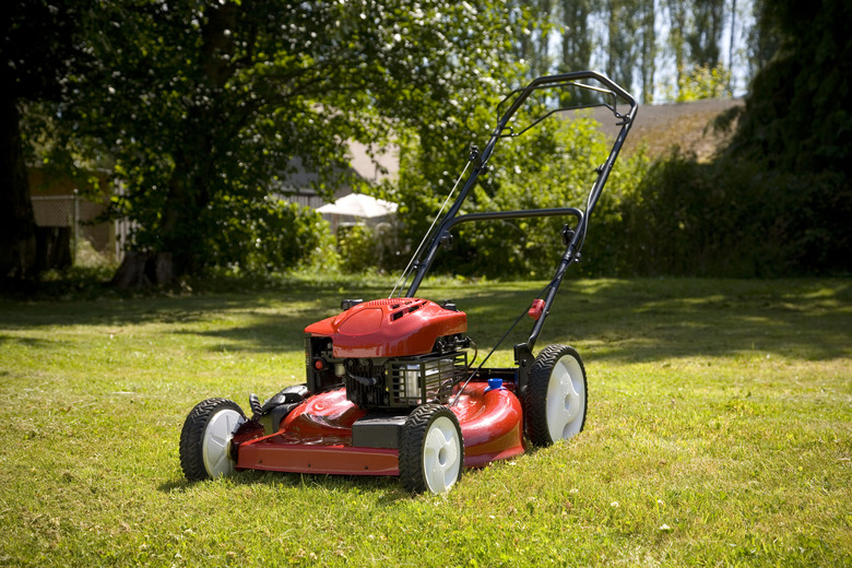 Lawn mower sitting alone on lawn