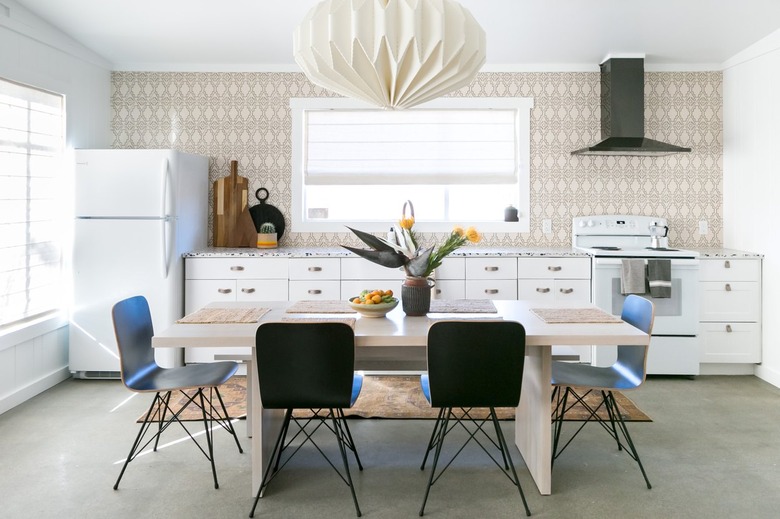 Origami-inspired lamp over dining table in kitchen.