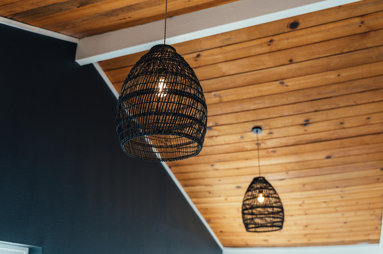 black pendant lights hanging from wood ceiling