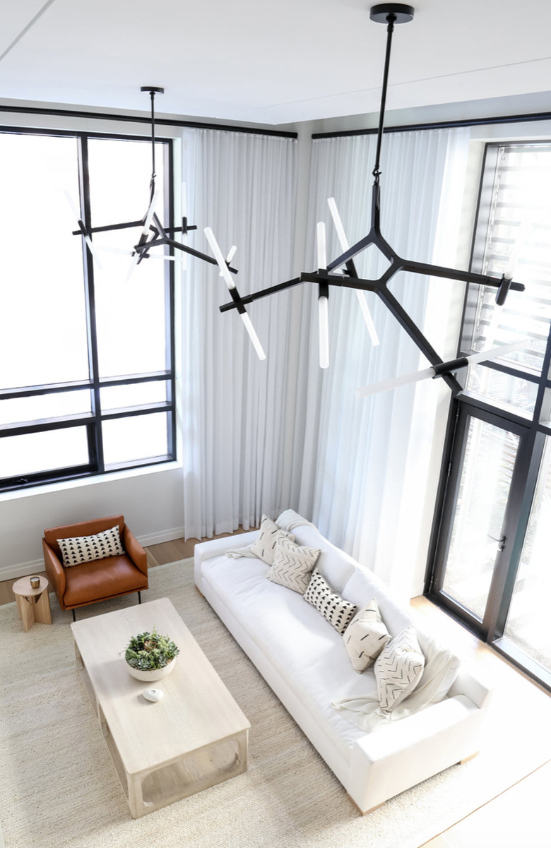 Contemporary chandeliers hung high as a pair.