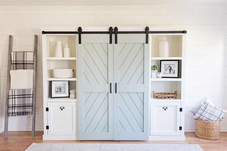 Barn doors hiding the middle of an entertainment stand