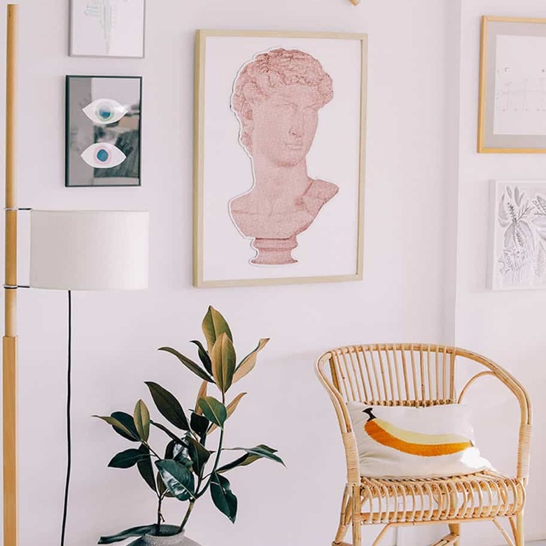 gallery wall with art and accent chair