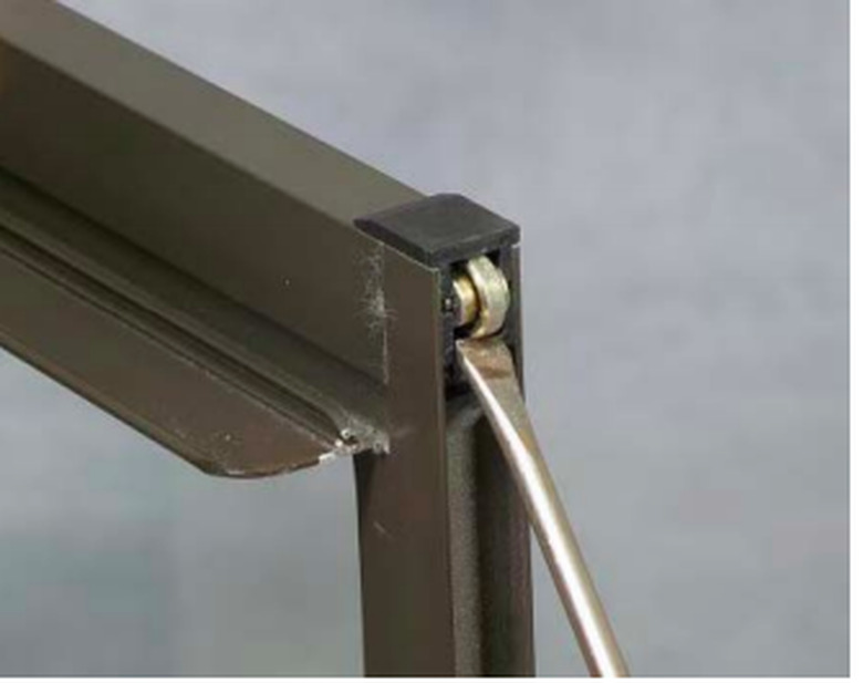 Closeup of sliding window roller.