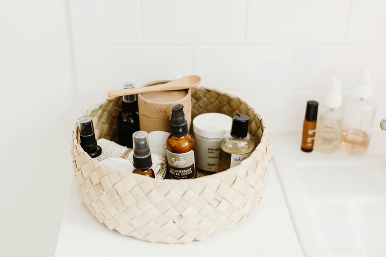 Makeup Organizer Ideas with Basket of beauty product on white bathroom counter