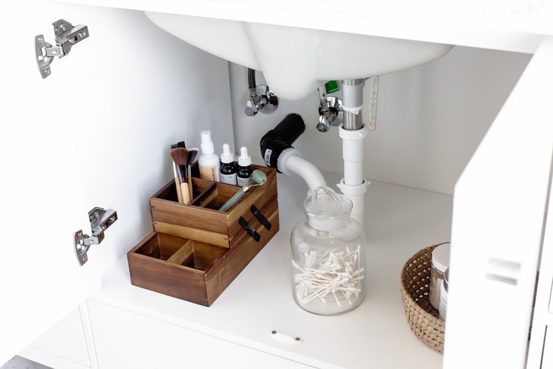 Makeup Organizer Ideas with Wood makeup organizer, glass canister, under the sink.