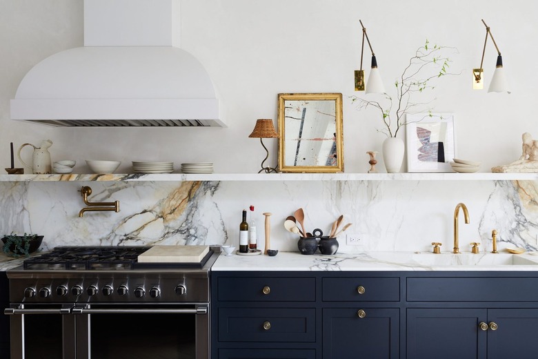 kitchen with marble countertops and integrated sink with blue cabinets