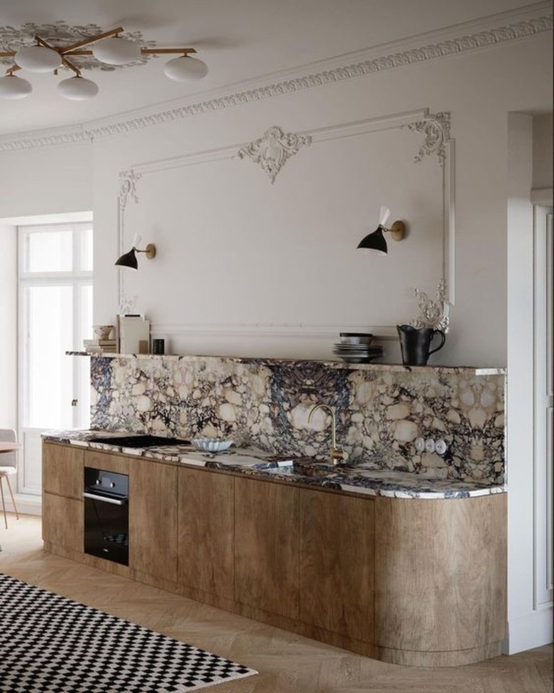 kitchen with marble sink, countertops, and backsplash with wood cabinets