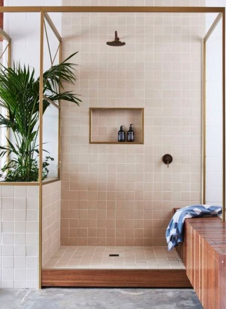 Plants and natural wood accents give a breezy island feel to this shower.