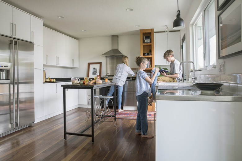 Family cooking and doing dishes in kitchen