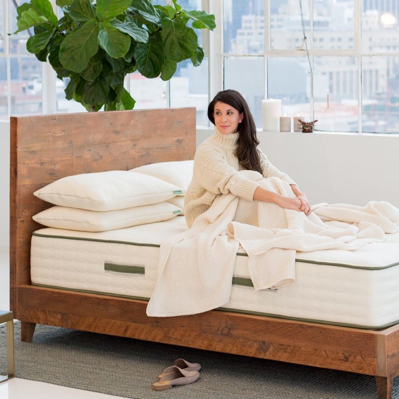 woman sitting on an avocado green mattress