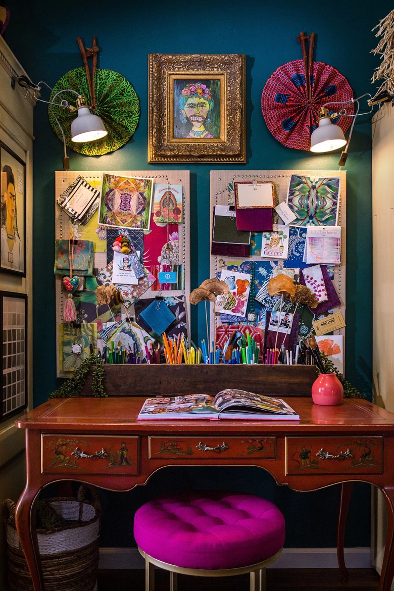 blue maximalist home office with large mood board hanging above the desk