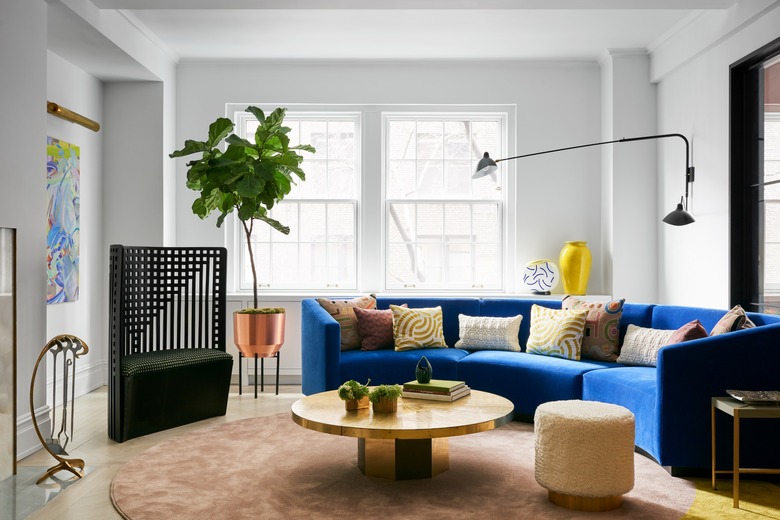 gray maximalist living room with blue sofa