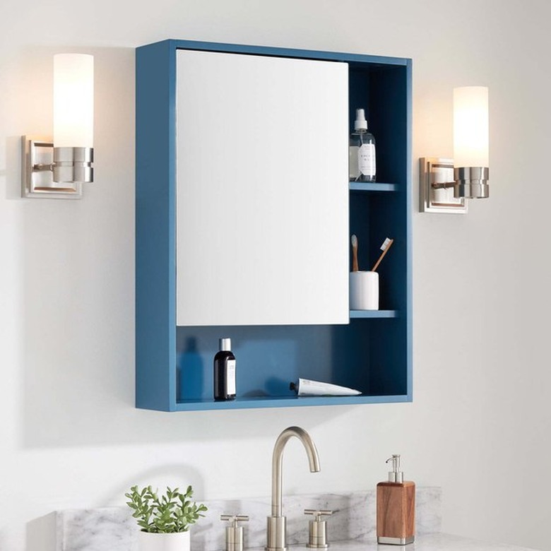 Medicine Cabinet Organization ideas in Blue medicine cabinet with open shelves, sconces, sink.