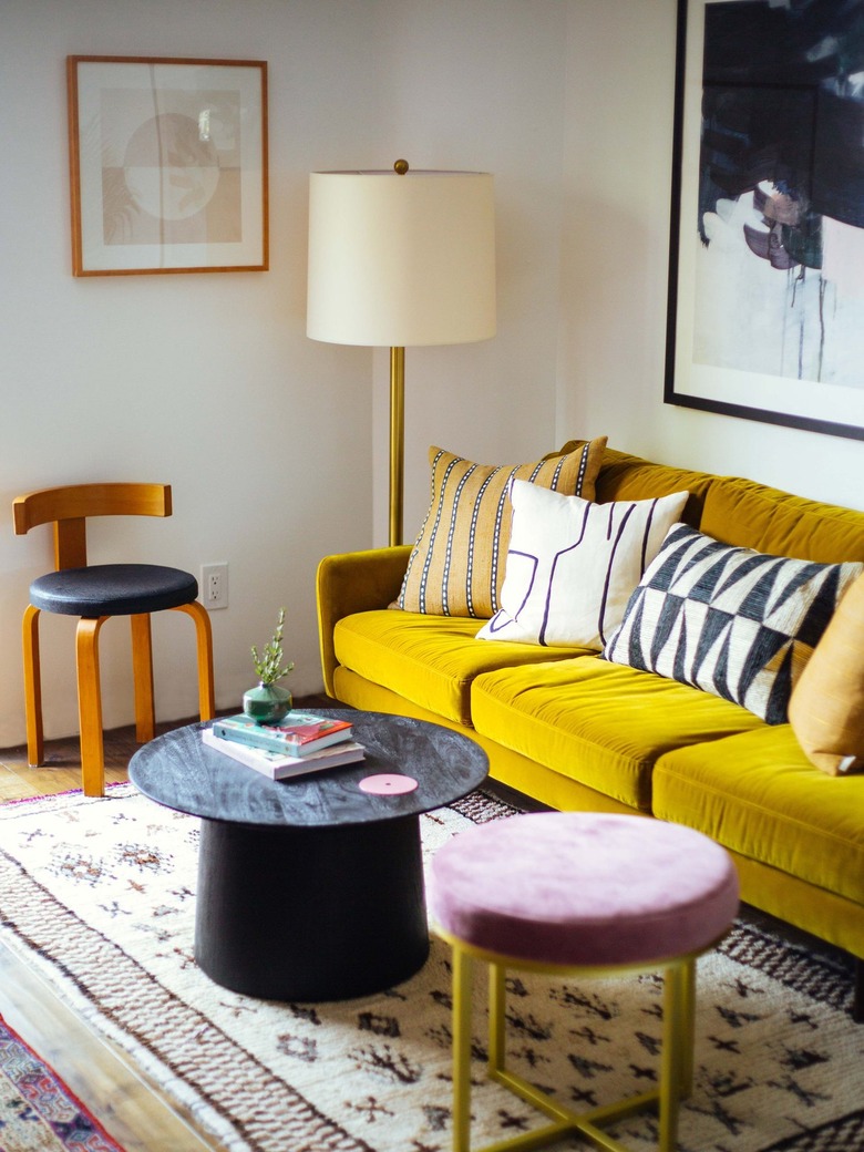 midcentury living room with yellow velvet sofa