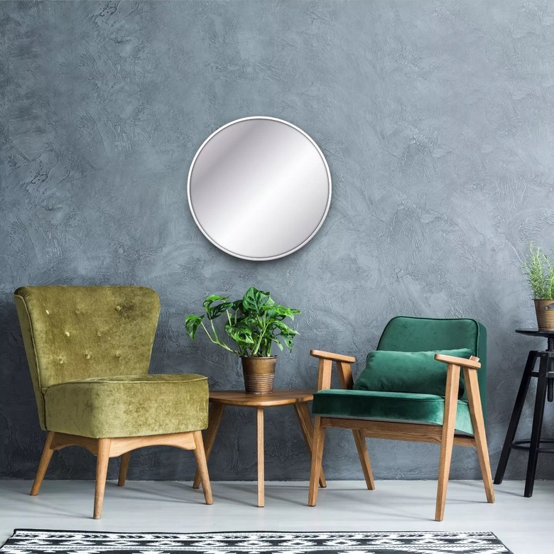 Circular mirror with accent chairs