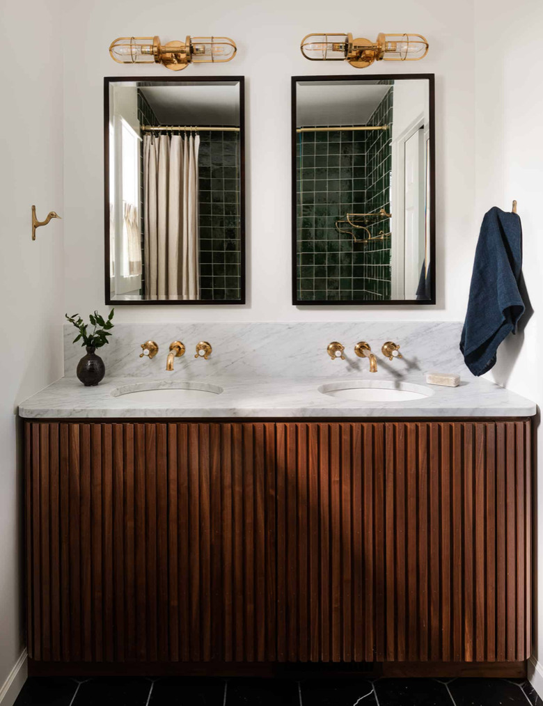 Midcentury Modern Bathroom Sink, brass wall mount faucets, mirrors, sconces, wood vanity, towel.