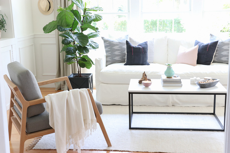 Midcentury modern bohemian living room with linear furniture and white colors