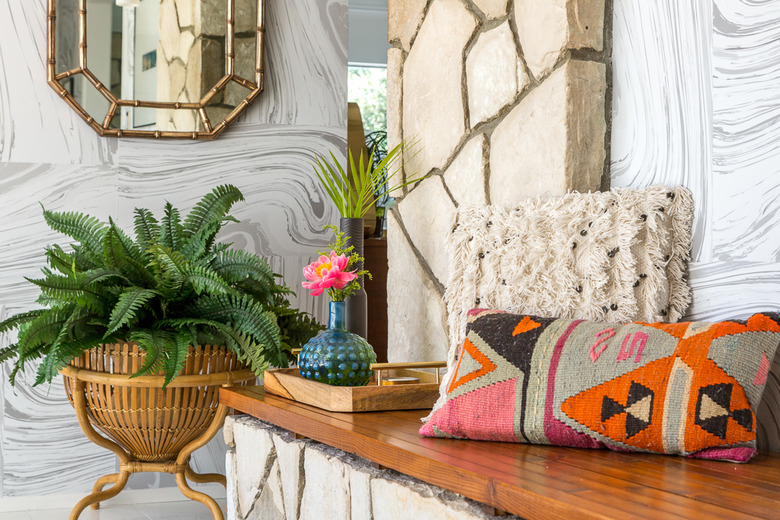 Midcentury modern bohemian entryway with colorful throw pillow and neutral colors