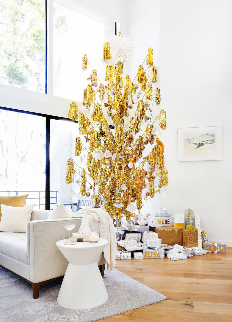 gold midcentury modern Christmas tree in white living room