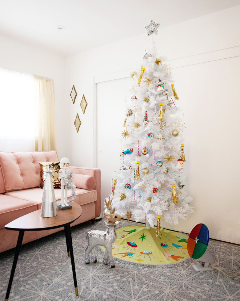 retro midcentury modern Christmas tree with ornaments and green tree skirt