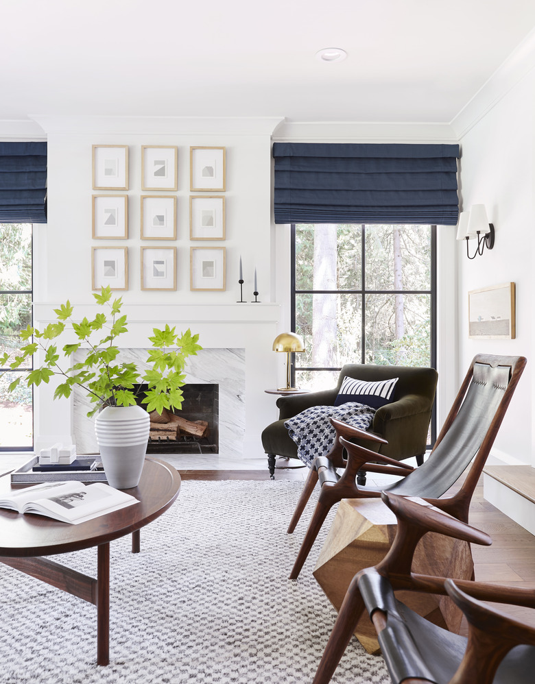 Bright midcentury modern family room design by Emily Henderson with oval wooden table and matching leather sitting chairs.