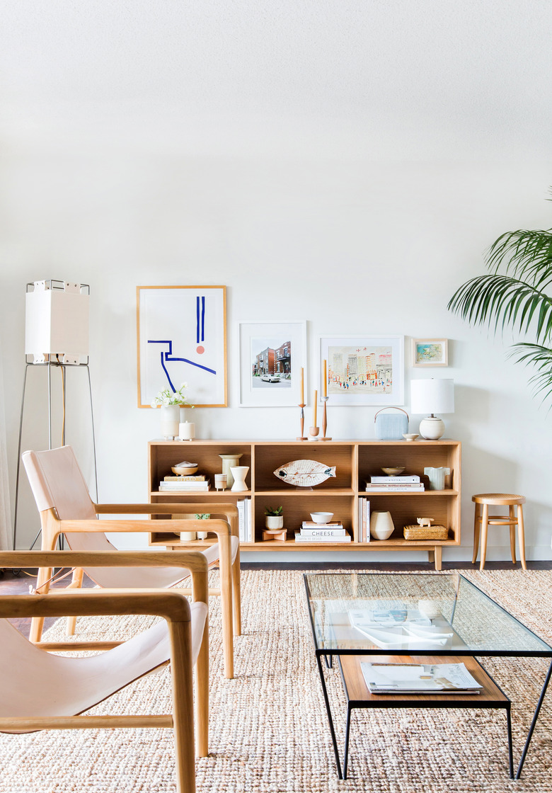 midcentury modern family room with light oak midcentury modern bookshelf and angled standing lamp.