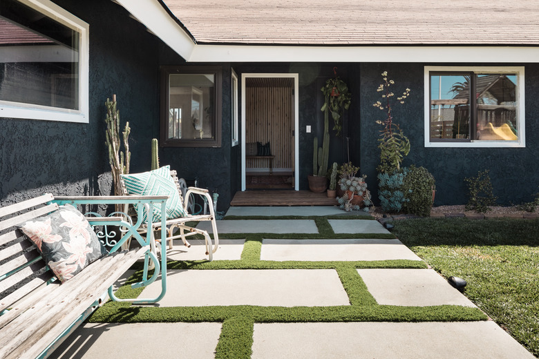 outdoor area of house with bench, chair, and concrete pathway