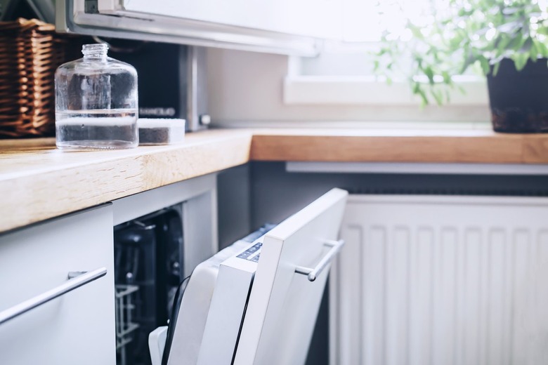 a clean kitchen with a dishwasher slightly ajar