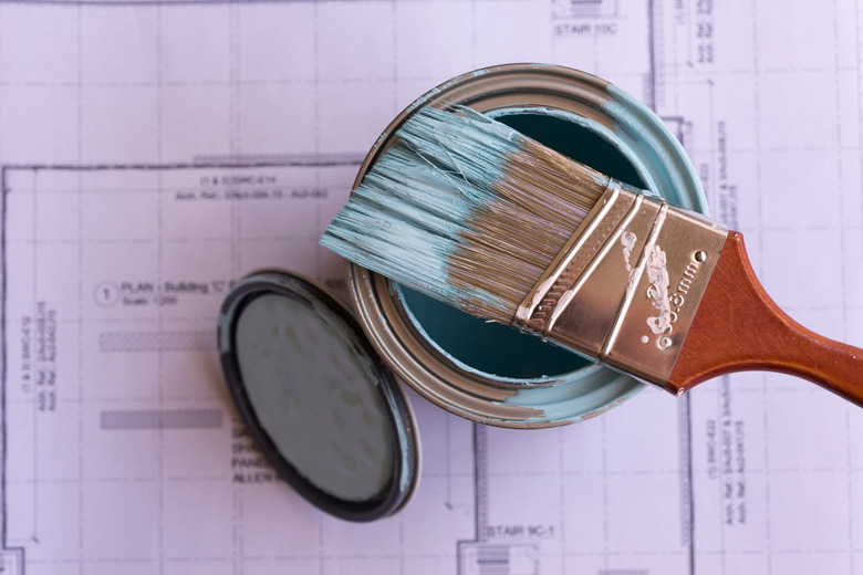 Close-Up Of Paintbrush On Paint Can At Table