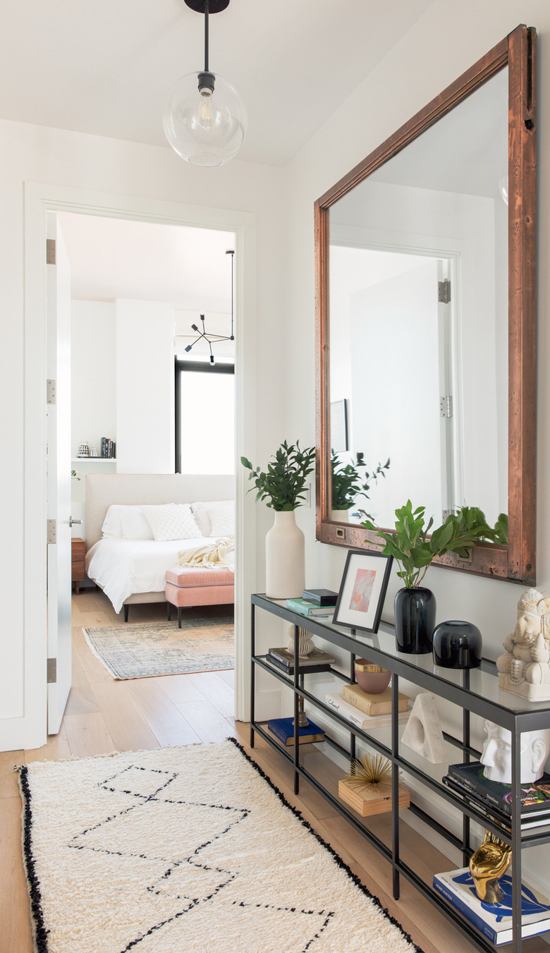 Hallway with large square mirror