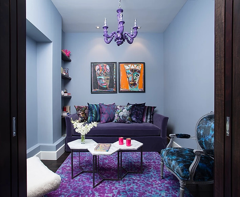 sitting room with purple rug and purple chandelier